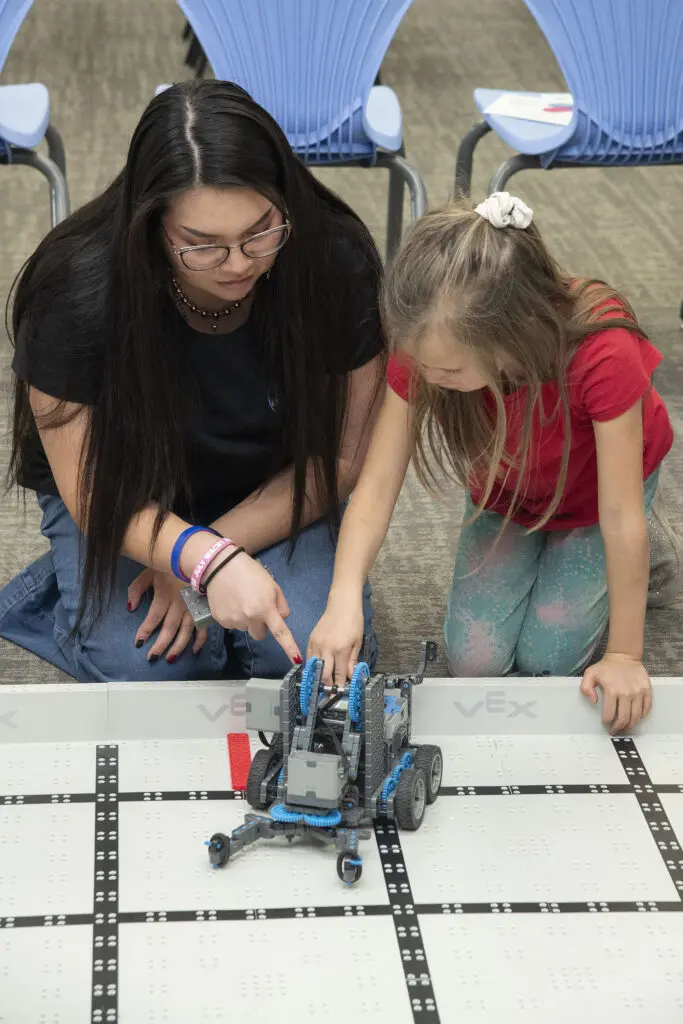 R4Creating staff member, Stevie Rae, is working with younger students in the STEAM Center of Excellence.