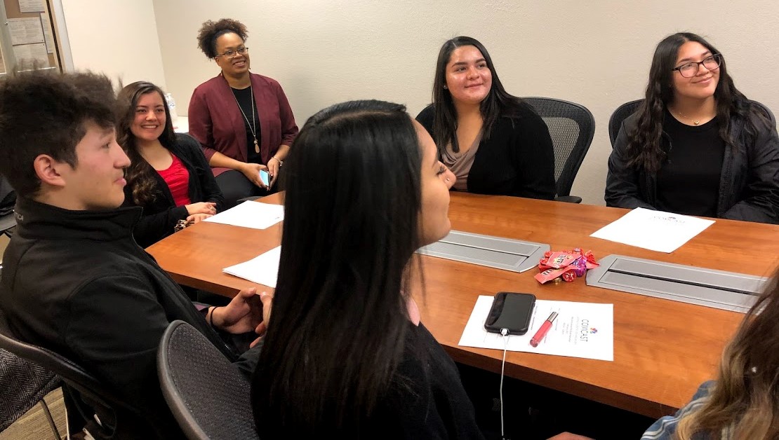 Students from Rio Grande High School sit around a conference table.