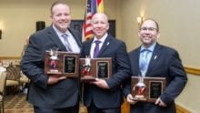 Southwest Cable Communications Association Hall of Fame inductees stand together as they hold their awards.